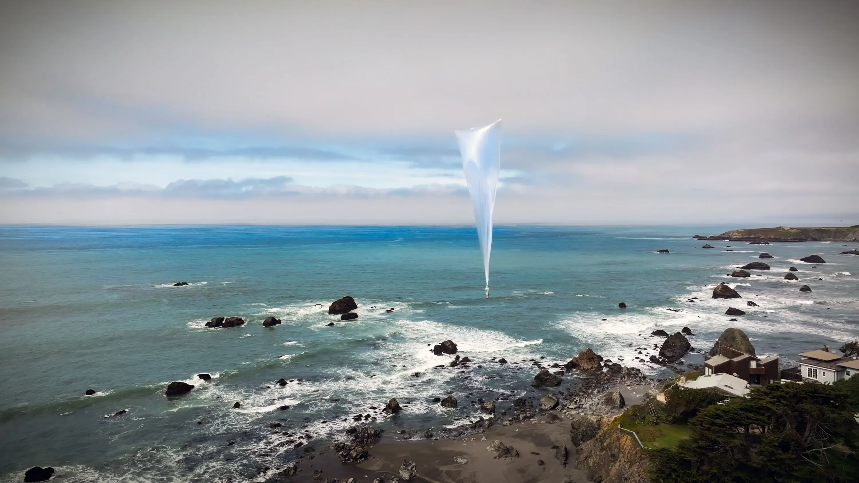 A WindBorne Global Sounding Balloon above a rocky coastline