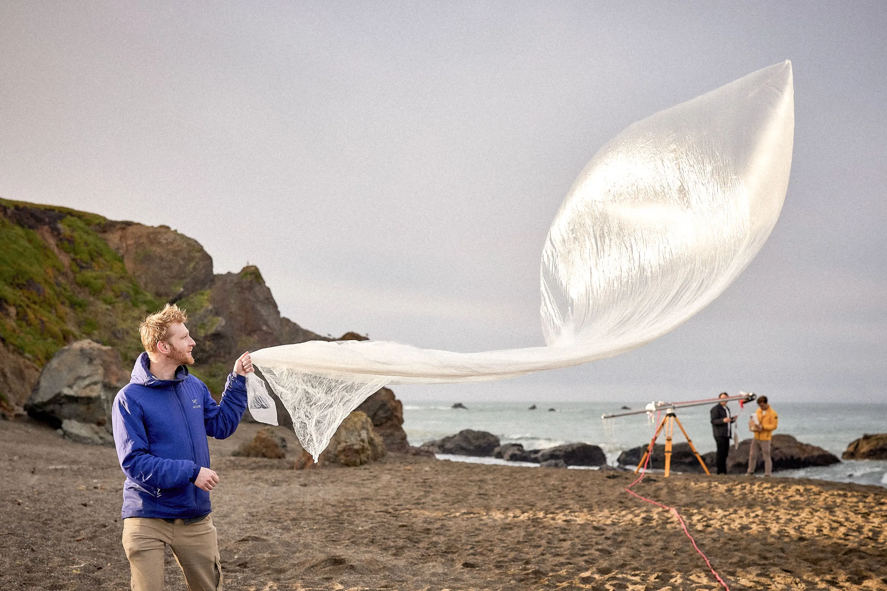 A WindBorne team member preparing a balloon system on the coast